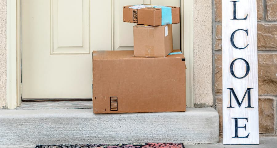 Boxes by the door of a residence with a welcome sign in Wichita